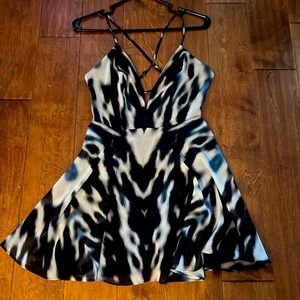 Bebe skater style dress. Small. Cross back straps. Back sip. Animal print.